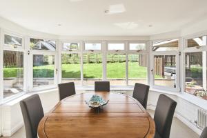 a dining room with a wooden table and chairs at Steward's Cottage 