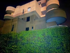 a building on top of a hill with bushes at Seveso Centro stazione , 15 minuti da Milano in Seveso