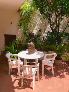 a patio with a table and chairs and plants at Via della Campana 17 in Portoferraio