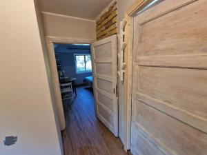 a hallway with a wooden door in a room at OZO Estrade No2 MINI apartment in Jūrmala