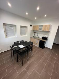 a kitchen with a table and chairs in a room at aPart mellett in Balatonfůzfő