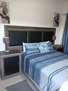 a bedroom with a bed and a tv at Prison View Guesthouse 2 in Klerksdorp
