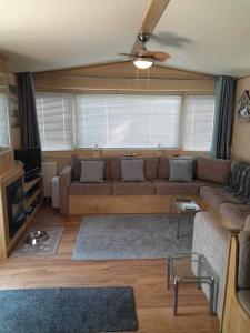 a living room with a couch and a ceiling fan at Happy place no4 in Ringwood