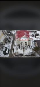 an aerial view of a building in the snow at Style Hotel in Ungheni