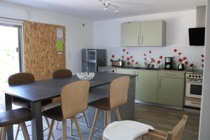 a kitchen with a dining room table and chairs at Chambre d'hôtes Les Cinq Mésanges 