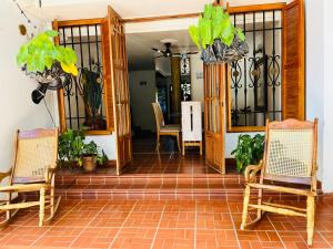 a porch with two chairs and a table at Casa Isabelita in Mompos