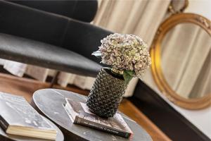 a vase filled with flowers sitting on a table at Brexton Hotel in Baltimore