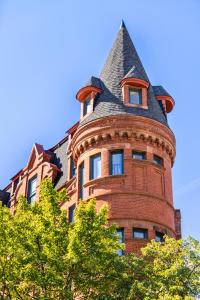 a tall brick building with a pointed roof at Brexton Hotel in Baltimore