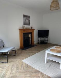 a living room with a fireplace and a television at Oasis in Buckinghamshire