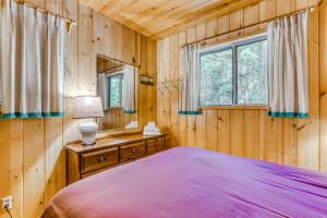 a bedroom with a bed in a wooden room at Ski Haus in Government Camp