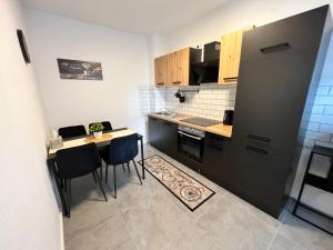 a small kitchen with a table and chairs in it at Appartment Florida Nähe Düsseldorf, Messe, HBF, City, Netflix, WIFI, HELIOS Hospital in Krefeld
