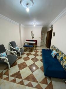 a living room with a couch and chairs and a piano at شقة للايجار اسكندرية in Alexandria