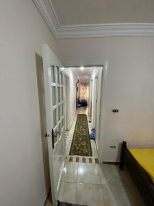 a hallway with a door leading to a room with a hallwayngthngthngthngth at شقة للايجار اسكندرية in Alexandria