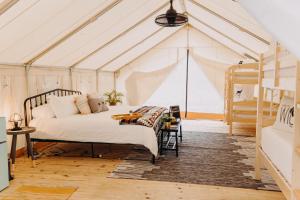 a bedroom with a bed in a tent at Timberline Glamping at Amicalola Falls in Dawsonville