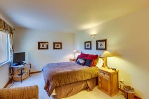 a bedroom with a bed and a television in it at Castillo De Las Rocas 3396 in Moab +18 photos
