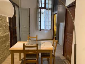 a dining room with a wooden table and chairs at Appartement centre historique in Montpellier