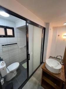 a bathroom with a white toilet and a sink at Wowo Loft Residence in Brazzaville
