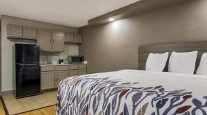 a hotel room with a bed and a kitchen at Red Roof Inn Chicago - N Aurora-Naperville in North Aurora
