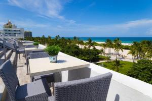 a balcony with tables and chairs and the beach at 1 Bedroom with King Bed and Roof-Top Pool and Bar C503 in Miami Beach
