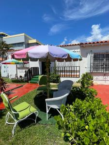 a patio with chairs and an umbrella at Habitacion Centrica Calle 8 Miami (2) in Miami