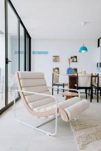 聖薩爾瓦多的住宿－¡Sivar Sound! Music Design!，一张带桌子的房间里白色椅子