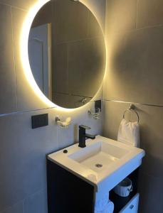 a bathroom with a sink and a mirror at Departamento con inmejorable vista a cerros in Villa La Angostura