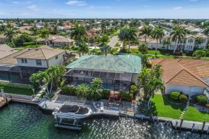 an aerial view of a house with a dock in the water at The Marco Mariner in Marco Island