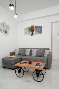 a living room with a couch and a coffee table at Amersa Luxury Apartment in Néa Alikarnassós