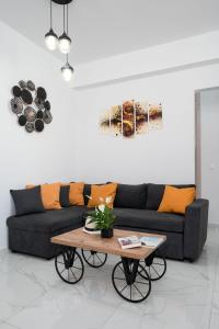 a living room with a couch and a coffee table at Amersa Luxury Apartment in Néa Alikarnassós