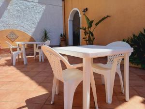 a white table and chairs on a patio at La Mimosa di Erice in Erice