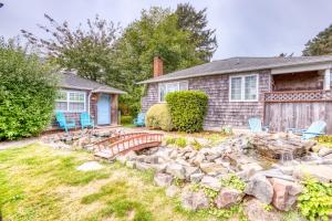 uma casa com um jardim de pedra e um lago em Hidden Villa Cottages #1, #2, and #3 em Cannon Beach