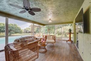 a living room with a couch and a ceiling fan at Ananda Farmhouse and Retreat. in Lake Worth