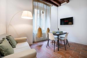 a living room with a couch and a table at FUNICOLARE 23 - Hystoric Apartment Immerso nel Cuore di Città Alta in Bergamo