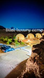 a building with cars parked in a parking lot at Bilal luxury camp in Wadi Rum