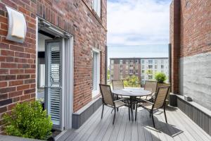 a balcony with a table and chairs on a brick building at voco The Tiger Hotel, Columbia, MO, an IHG Hotel in Columbia