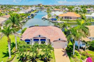 an aerial view of a house with palm trees and a canal at Goldenrod House is Your Golden Ticket to Paradise! in Marco Island