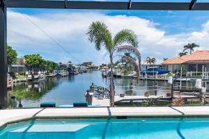 a swimming pool with a view of a canal at The Goldenrod House I Ultimate Escape on Marco Island in Marco Island