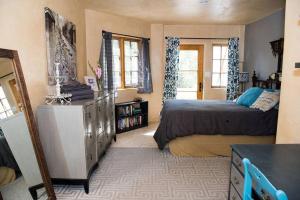a bedroom with two beds and a dresser in it at Sun and Ski! Beautiful, Downtown, on 1.5 Acres! in Santa Fe