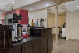 a kitchen with a counter with a coffee maker at HomeTowne Studios by Red Roof Painted Post in Painted Post