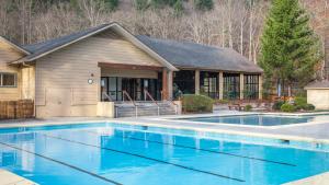 a house with a swimming pool in front of a house at Fairway Forest in Sapphire