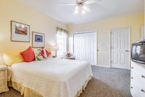 a bedroom with a bed and a tv at Stingray Isle in Dauphin Island +36 photos