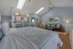 a bedroom with a large bed and a living room at Sea Dream and Sand Dollar Suite in Fort Bragg