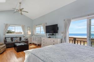 a bedroom with a bed and a view of the ocean at Sea Dream and Sand Dollar Suite in Fort Bragg