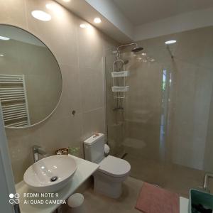 a bathroom with a shower and a toilet and a sink at Apartment MONAS I in Pješčana Uvala 