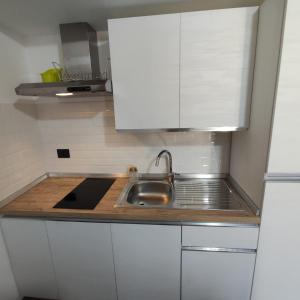 a kitchen with a sink and a counter top at Case Gemmellaro - Family in Nicolosi