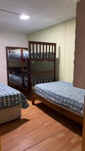 a room with three bunk beds in it at Hostel 53 Sur in Puerto Natales
