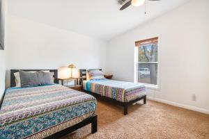 a bedroom with two beds and a window at Spanish Valley Vineyard - Both homes in Moab