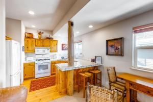 a kitchen with wooden cabinets and a white refrigerator at Sun Bird Getaway at River Run in Ketchum