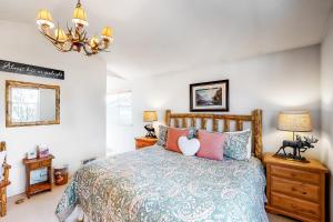 a bedroom with a bed and a chandelier at Sun Bird Getaway at River Run in Ketchum