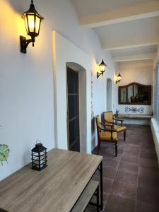 a living room with a wooden table and chairs at Hermosa Hacienda Las Heliconias in Oaxaca City